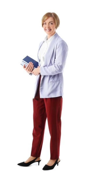 Female teacher with notebooks on white background - Photo, image