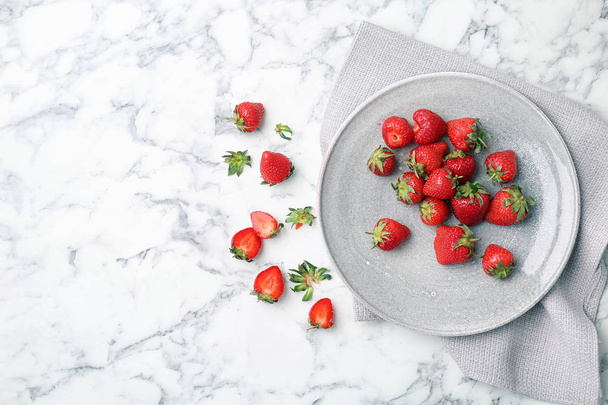 Flat lay composition with ripe red strawberries on marble background - Photo, image