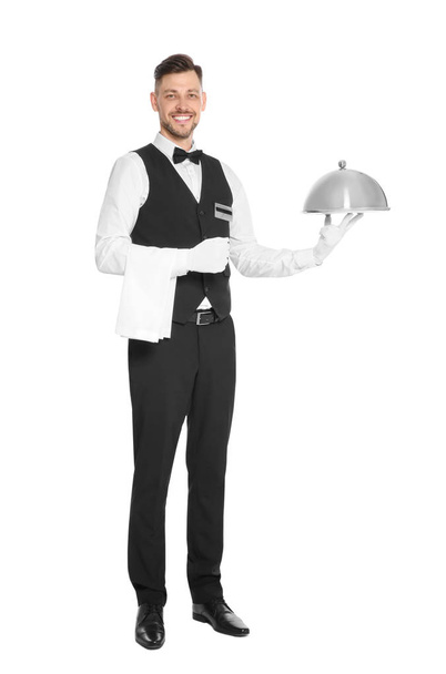 Handsome waiter holding metal tray with lid on white background - Φωτογραφία, εικόνα