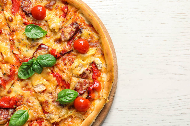 Delicious pizza with tomatoes and sausages on table, top view - Photo, image