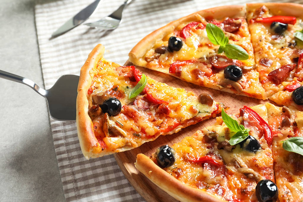 Delicious pizza with olives and sausages on table - Photo, image