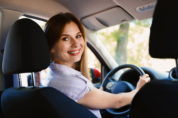 Happy beautiful woman driving modern car - Фото, зображення