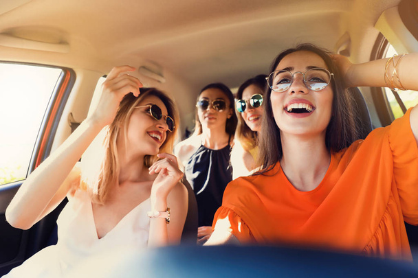 Happy beautiful young women together in car - Foto, Imagen