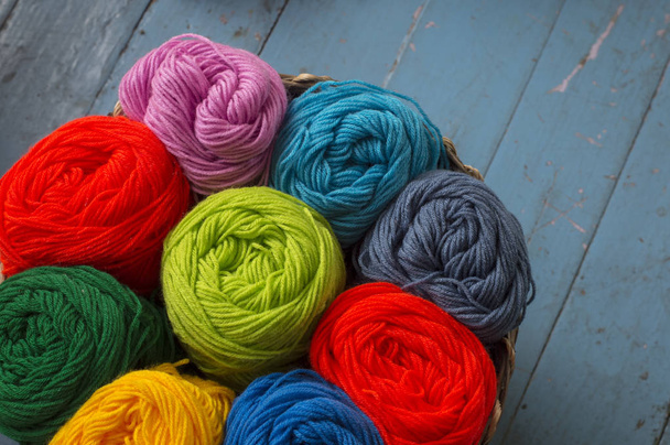 Colorful yarn wool for knitting in basket on table - 写真・画像