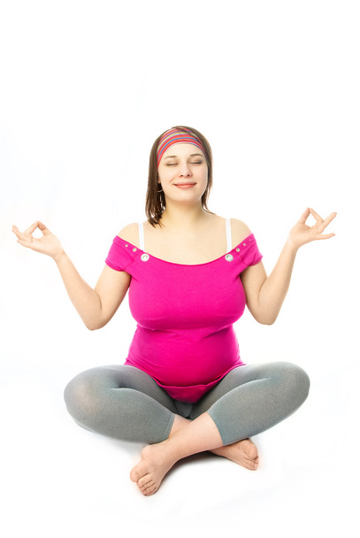Pregnant woman in lotus pose - Фото, изображение