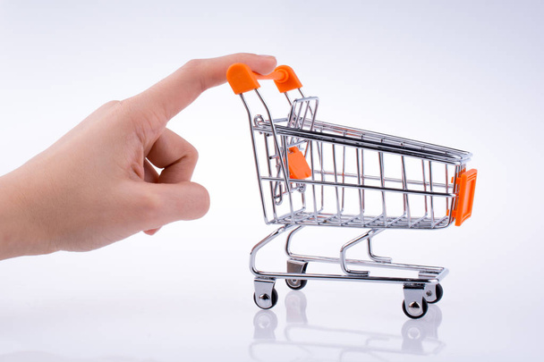 Hand holding a Cart on a white background - Photo, Image
