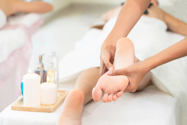 Foot spa massage treatment by professional massage therapist in luxury spa resort. Wellness, stress relief and rejuvenation concept. - Valokuva, kuva