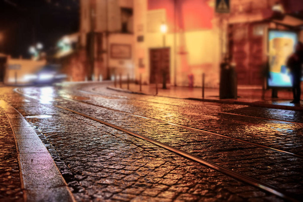 Illuminated street of old european town at night. Tilt-shift effect - Photo, Image