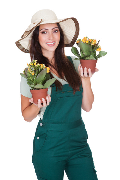Beautiful Happy Woman Holding Flower Plant - Valokuva, kuva