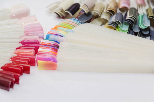 Fan of nail art polish tips samples isolated on white. - Foto, Bild