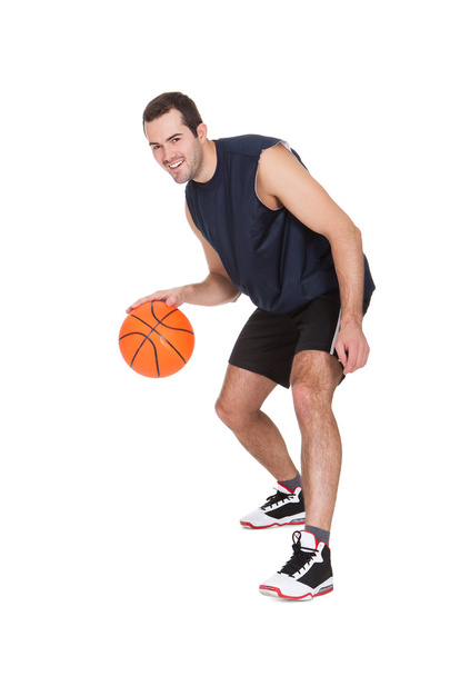 Professional basketball player with ball - Foto, afbeelding