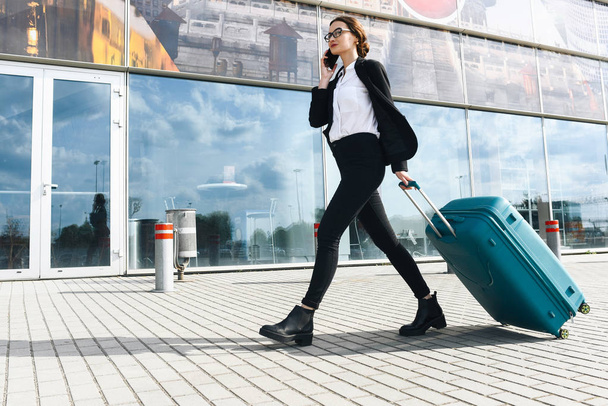 . Business woman at international airport moving to terminal gate for airplane travel trip - Mobility concept and aerospace industry flight connections - Foto, imagen