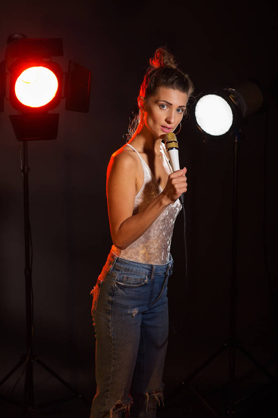 A woman sings a song in the studio - Photo, Image