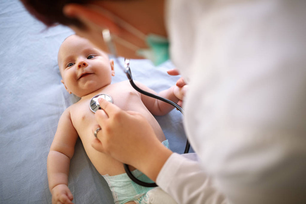 Lovely baby is checking up with stethoscope by pediatrician - Fotoğraf, Görsel