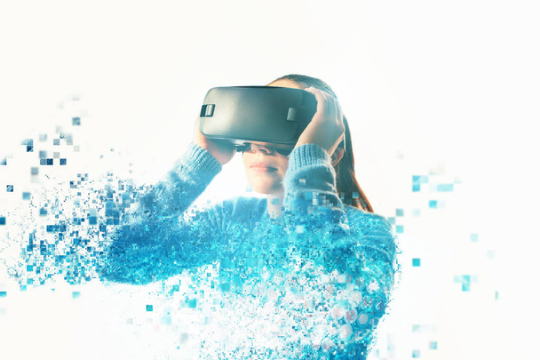 A person in virtual glasses flies to pixels. The woman with glasses of virtual reality. Future technology concept. Modern imaging technology. Fragmented by pixels. - Photo, Image