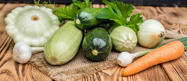 The ripened vegetable marrows, zucchini and bush pumpkins are prepared as ingredients for preparation of healthy food. It can be used as a background - Zdjęcie, obraz