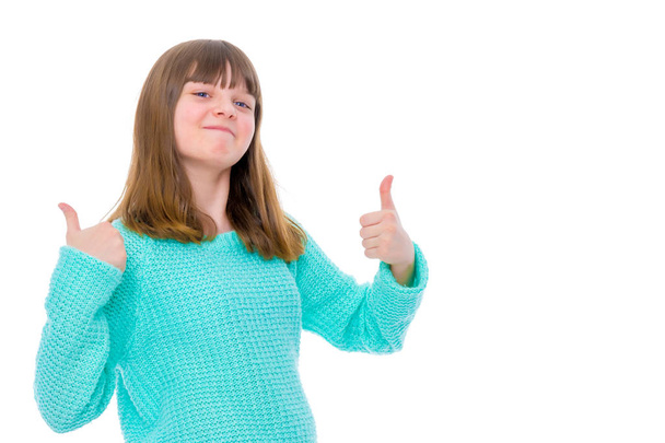 Дівчина-підліток тримає великий палець вгору
 - Фото, зображення