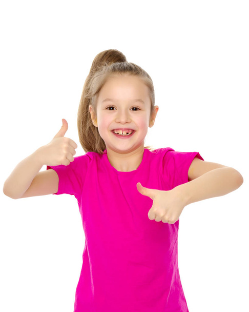 Little girl holding her thumb up - Фото, изображение