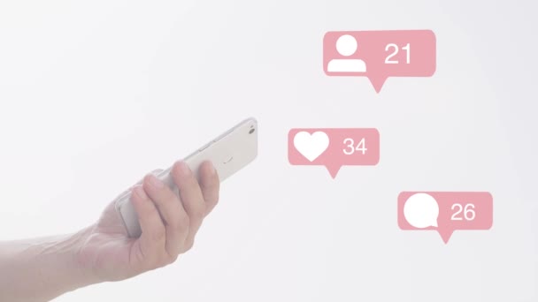 Young Adult man holding smartphone in hand - with follower, comments, likes counting bubble, - Footage, Video
