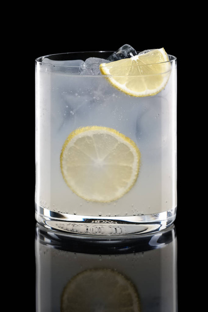 Vodka and tonic in Rocks glass isolated on black - Фото, зображення