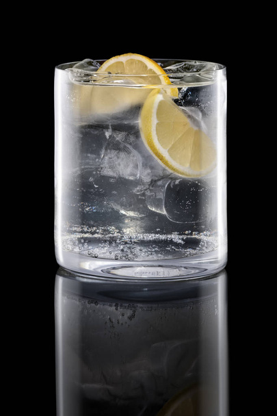 Gin and tonic in Rocks glass isolated on black - Photo, image