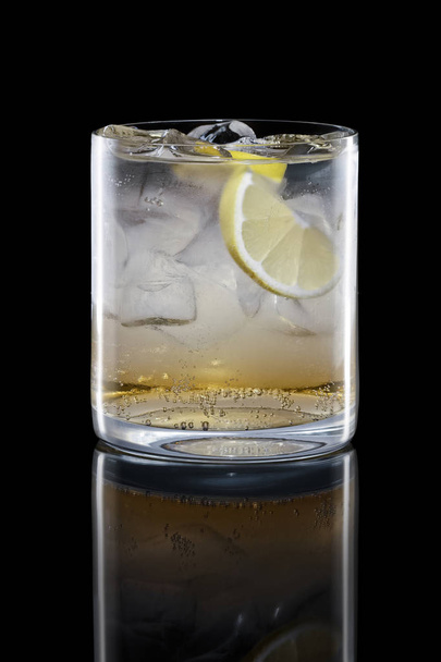 Apple bourbon and tonic in Rocks glass isolated on black - Foto, Imagen