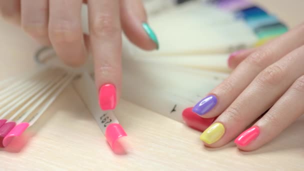 Manicured hand choosing nail polish. - Footage, Video