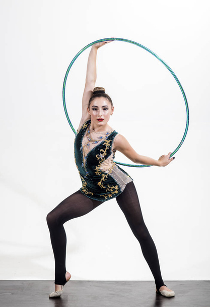 Woman with gymnastic ring. Workout sports activities in gym of flexible girl. Sport success and health. Woman train acrobatics with hula hoop in sportswear. Fitness and dieting of girl gymnast - Photo, image