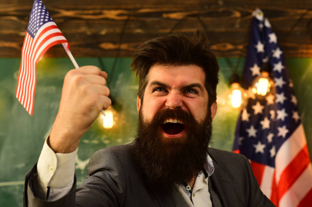 expressive businessman with american flag in raised hand. - Fotoğraf, Görsel