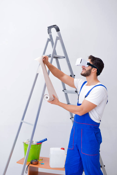 Man with VR glasses gluing wallpaper - Photo, Image