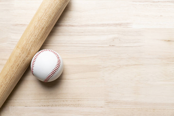 baseball and baseball bat on wooden table background, close up - Фото, изображение
