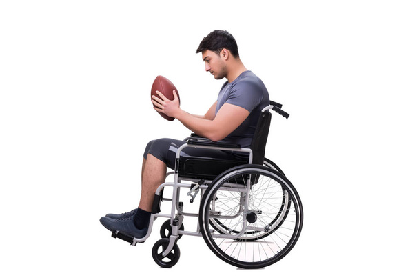 Football player recovering from injury on wheelchair - Photo, Image