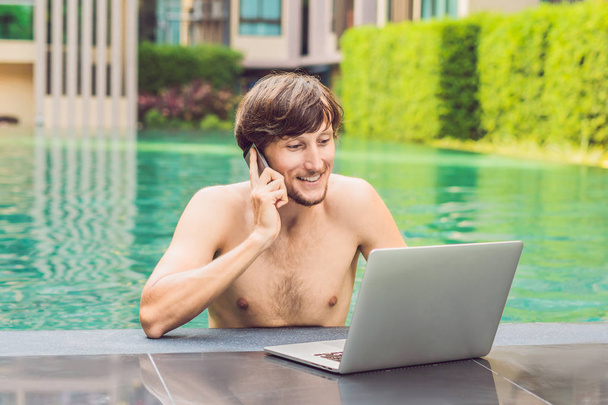 Young freelancer working on vacation next to swimming pool - Zdjęcie, obraz