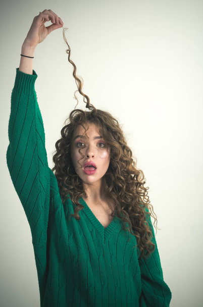 Real woman with beauty brunette hair shows curls. - Фото, зображення