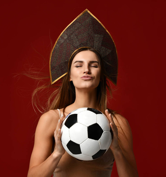 Russian style Fan sport woman player in kokoshnik hat hold soccer ball celebrating happy smiling with free text copy space on red - Valokuva, kuva