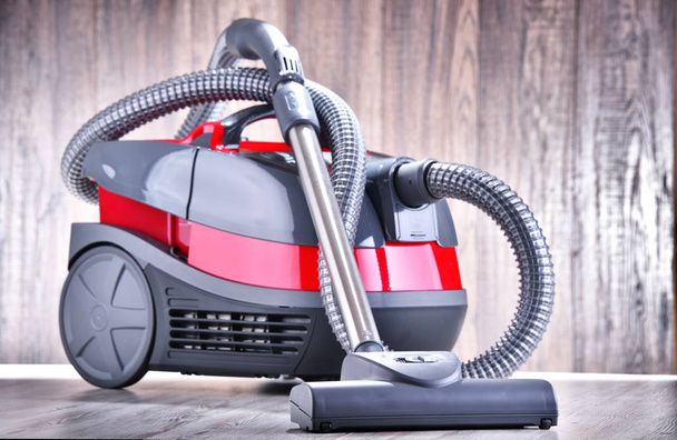 Canister vacuum cleaner for home use on the floor in the apartment. - Photo, Image