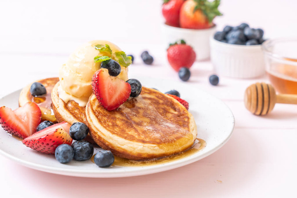 souffle pancake with blueberries, strawberries, honey and vanilla ice-cream - Photo, Image