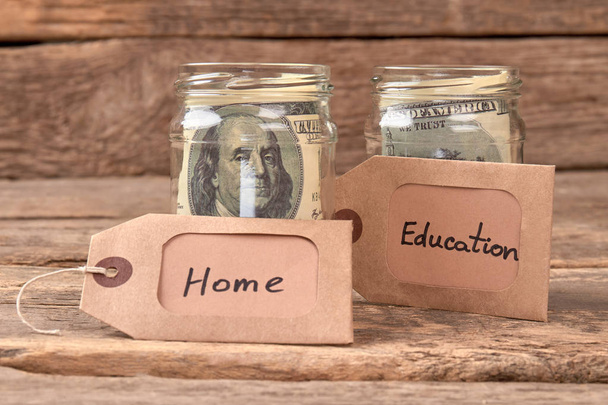 Glass jars with dollars for home and education. - Photo, Image