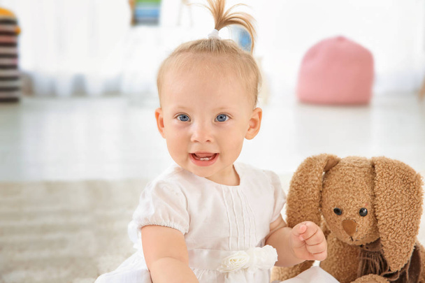 Adorable baby girl with cute toy at home - Фото, зображення