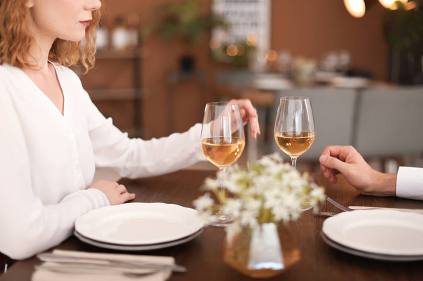 Young couple with glasses of delicious wine in restaurant - Foto, Imagem