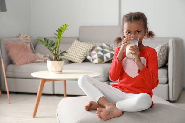 Adorable African-American girl with glass of milk at home - Foto, Imagem