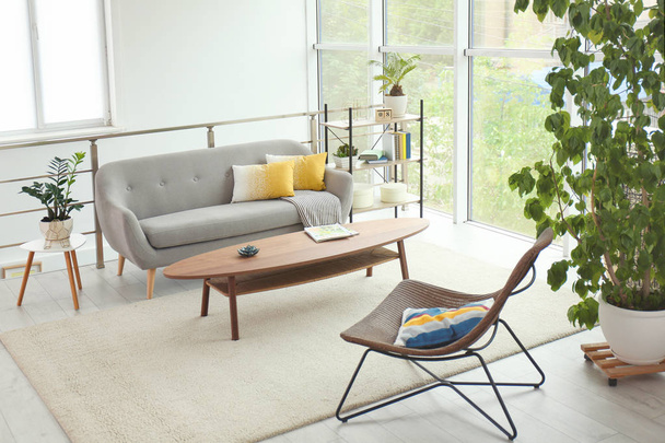 Elegant living room interior with comfortable sofa and coffee table - Фото, изображение