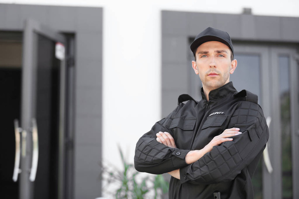 Portrait of male security guard in uniform outdoors - Фото, изображение