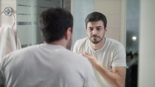 Man Suffering Trimming Eyebrow In Home Bathroom - Felvétel, videó