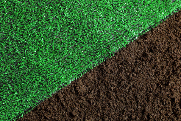 Green artificial grass on soil, top view. Gardening - Valokuva, kuva