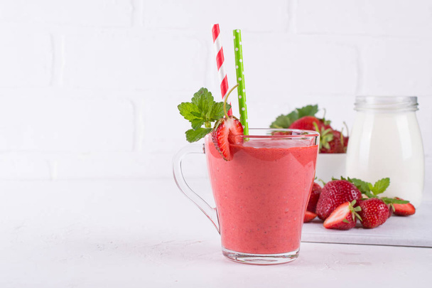 Strawberry smoothie or milkshake in glass cup. Healthy food for breakfast and snack - Photo, Image