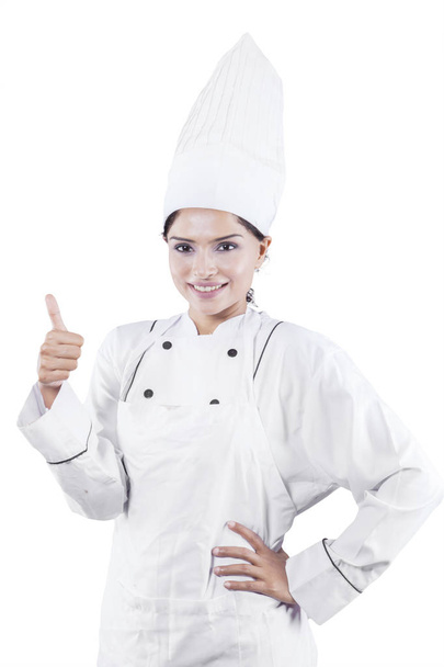 Portrait of Indian female chef is showing thumb up while standing in the studio, isolated on white background - Fotografie, Obrázek