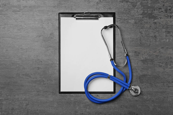 Clipboard and stethoscope on table. Urology concept - Photo, image
