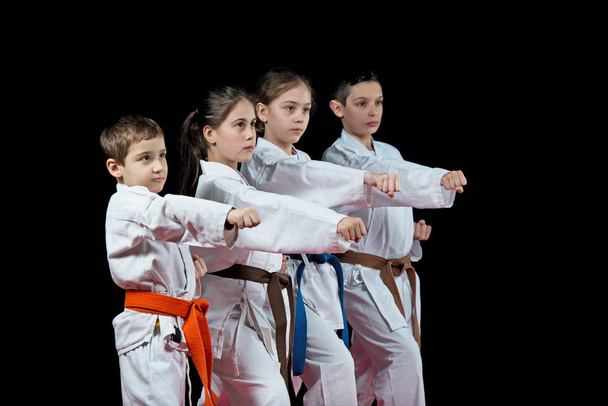 Children are training karate on black background - Photo, Image