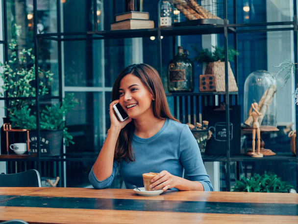 Asian woman drinking coffee in  coffee shop cafe - 写真・画像